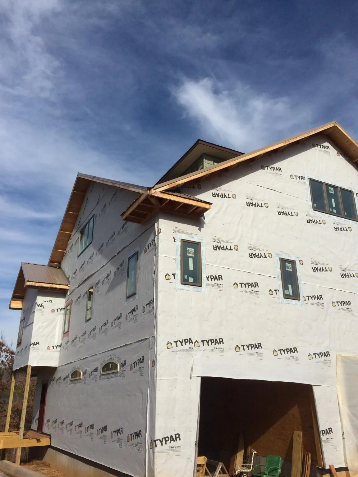 Stick built house wrapped in Typar with new roof framing and dormers in Hopedale